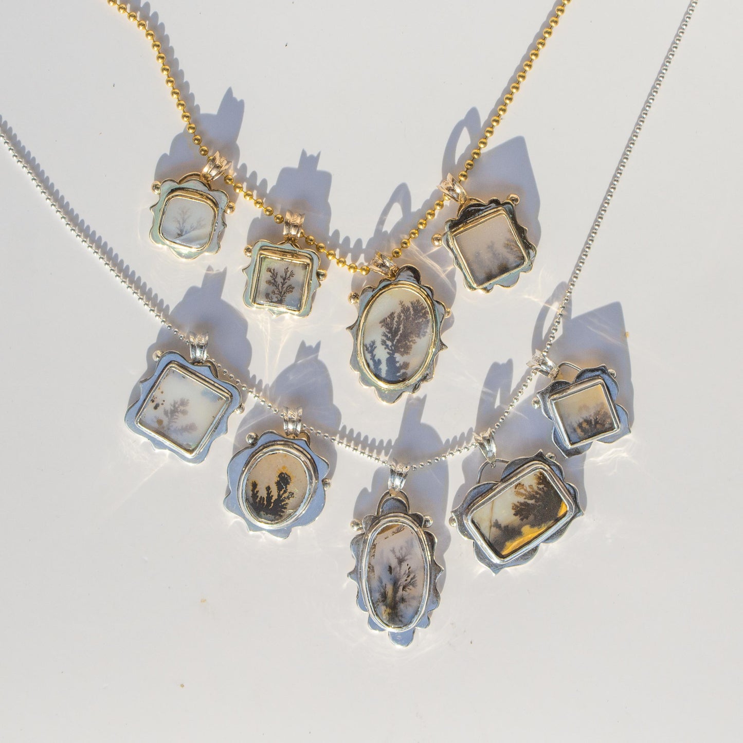 Necklace with multiple pendants on a light background